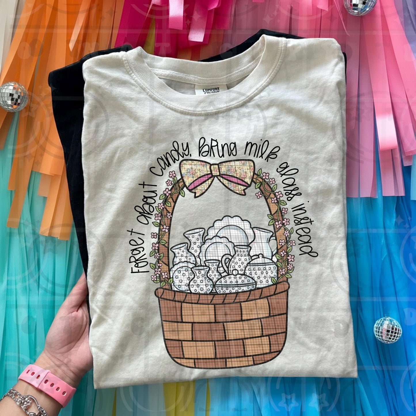 Vintage cottagecore illustration of milk glass pieces in a woven basket with florals and the phrase forget about candy bring milk glass instead
