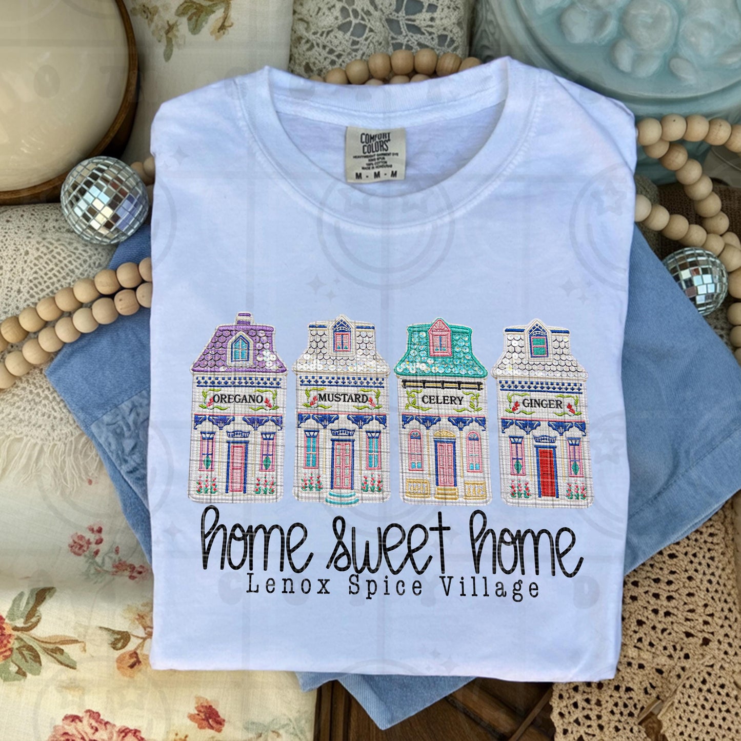 Faux embroidery spice village design with illustrated spice houses labeled oregano mustard celery and ginger and the phrase home sweet home lenox spice village