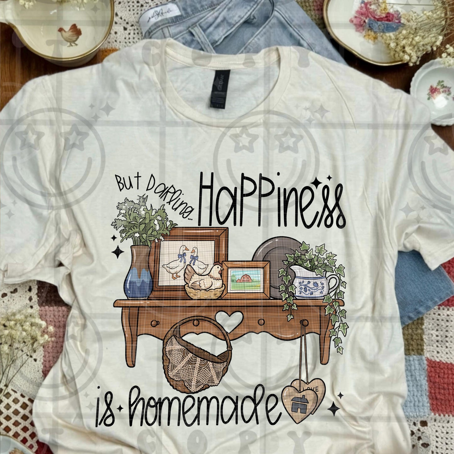Cottagecore style illustration showing a vintage farmhouse table with framed ducks ivy plant ceramic crock crockery baskets and rustic decor with the phrase happiness is homemade