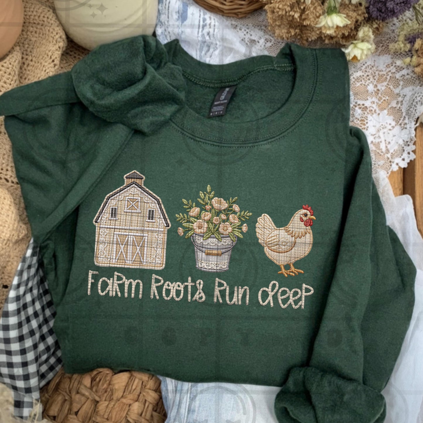 Farmhouse faux embroidery style design showing a rustic barn a potted floral arrangement and a chicken with stitched text reading Farm Roots Run Deep in neutral country colors