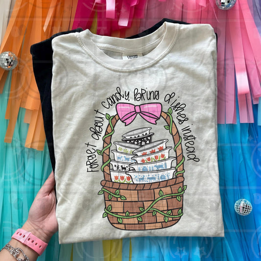 Vintage cottagecore illustration of stacked dishes in a woven basket with greenery and the phrase forget about candy bring dishes instead