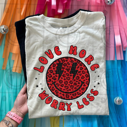 Love more worry less faux embroidery style quote with stitched look lettering and soft vintage colors