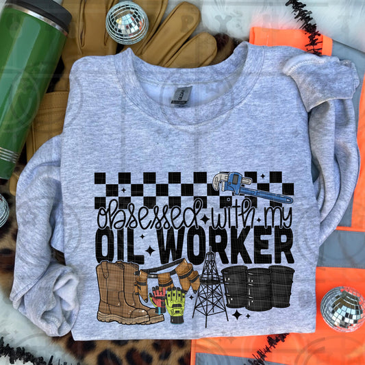 Obsessed with my oil worker design with work boots gloves oil derrick oil barrels and industrial themed lettering on gray background