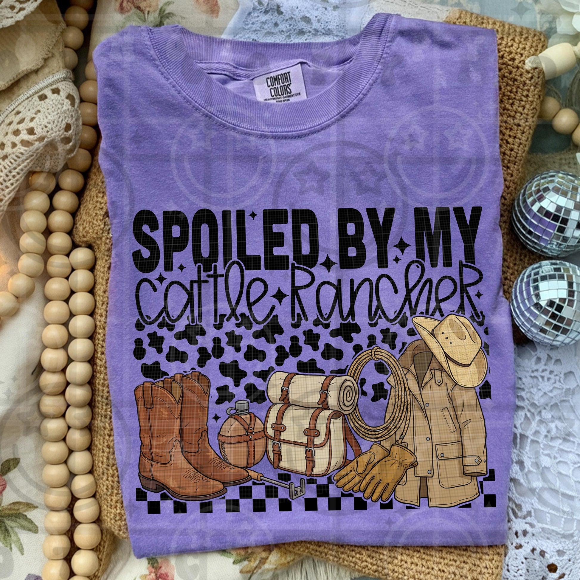 Western ranch themed illustration with cowboy boots rope gloves ranch coat canteen and text spoiled by my cattle rancher