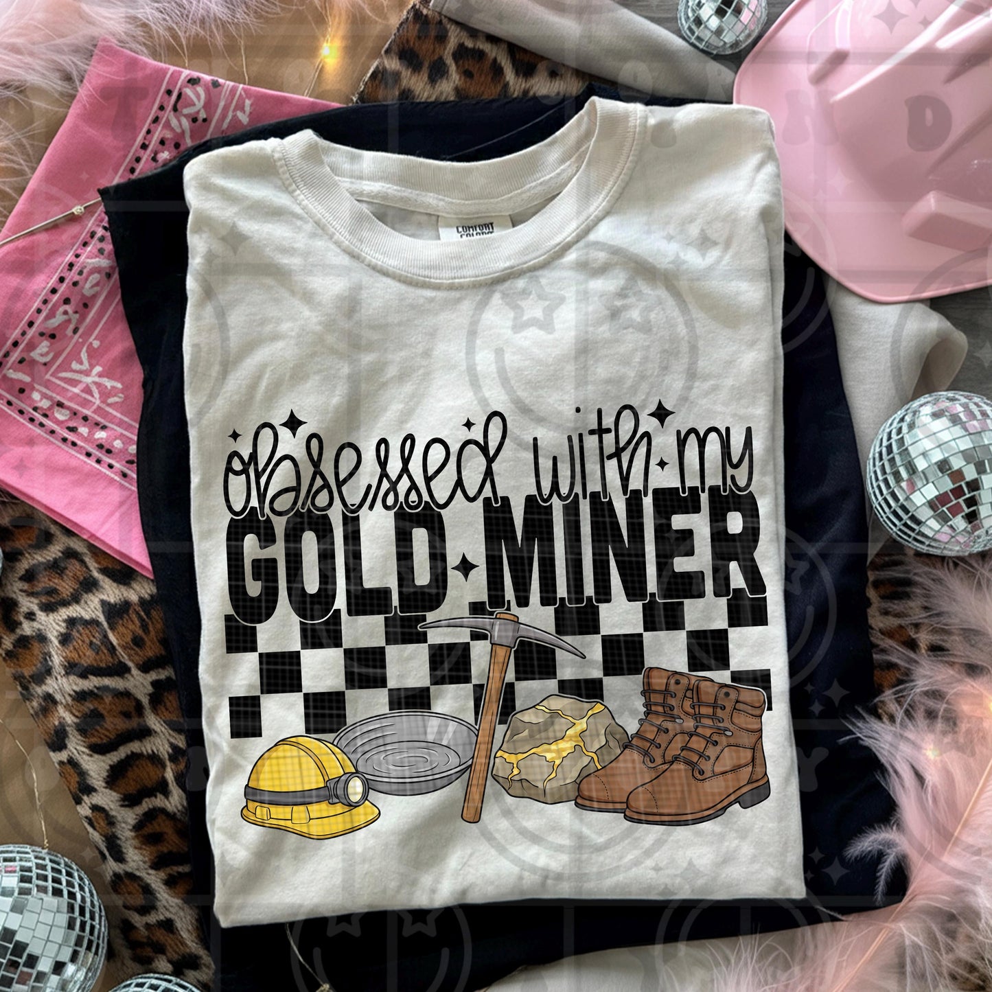 Obsessed with my gold miner text design featuring a hard hat mining pan pickaxe gold ore rock and brown work boots in a retro blue collar illustration style